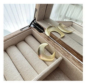 Matte gold S925 sterling silver C-shaped earrings in a wooden jewelry gift box