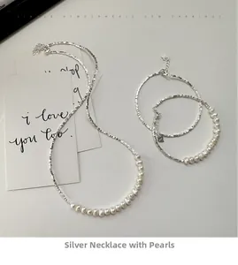 Detailed view of S925 sterling silver necklace and bracelet set with white pearls