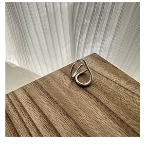Close-up of minimalist S925 silver ring featuring abstract double-layer curved twist design