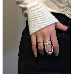 Close-up of minimalist S925 sterling silver ring with abstract curved lines on model's hand