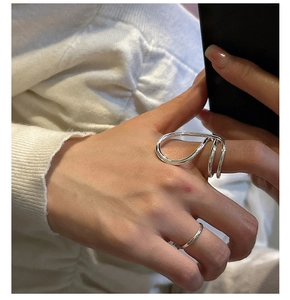 Artistic S925 sterling silver wide hollow streamlined ring set on model's hand