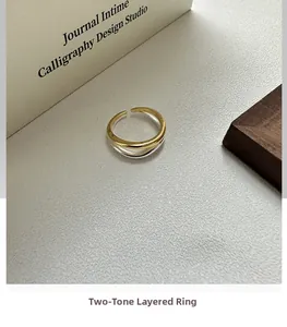 Detailed close-up of double-layered wavy ring with gold and silver two-tone finish