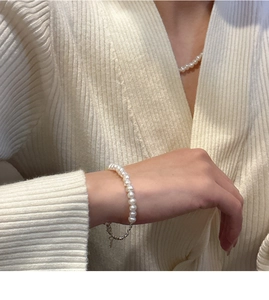 Close-up of elegant S925 sterling silver pearl necklace and bracelet set on a model
