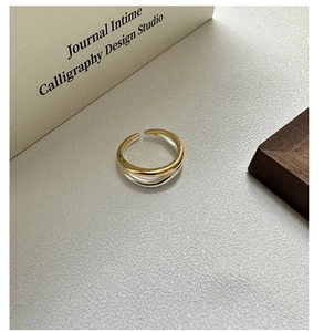 Detailed shot of S925 silver and gold wave ring showing the intertwined layered design