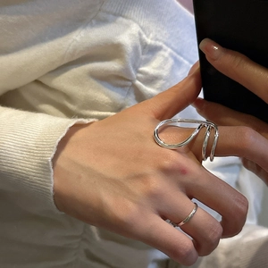 Minimalist S925 sterling silver ring with sculptural streamline design worn on finger