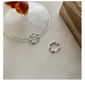 Close-up of S925 sterling silver hoop earrings with a minimalist twisted texture