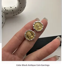 Detailed macro view of two-tone S925 silver and gold coin stud earring with relief