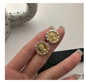 Close-up of S925 silver vintage coin earrings with gold portrait and wavy silver border