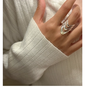 Detailed view of S925 sterling silver triple-layered V-shaped wavy ring on model