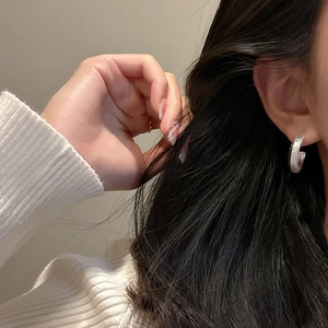Elegant S925 sterling silver C-shape stud earrings with a shimmering brushed texture on ear