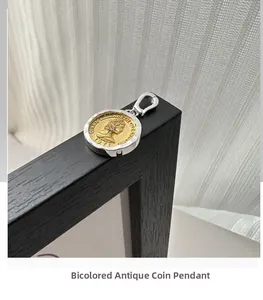 Macro view of vintage silver and gold coins pendant with Queen Elizabeth portrait