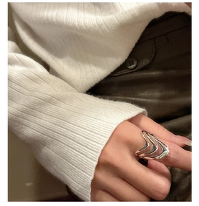 Close-up of wavy S925 sterling silver layered ring with modern artistic liquid metal texture