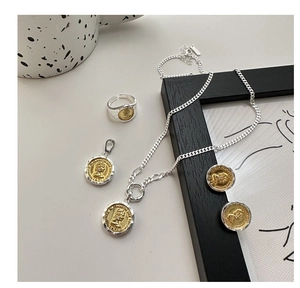 Detail of vintage S925 silver coin jewelry set with Elizabeth II portrait engraving