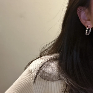 Elegant S925 sterling silver hoop earrings with a continuous star pattern on model