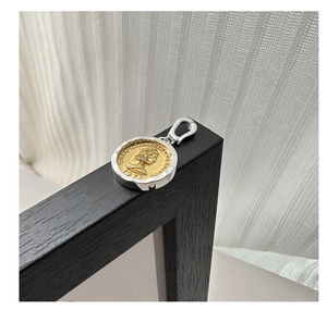 Macro shot of S925 sterling silver two-tone coin pendant with Queen Elizabeth portrait