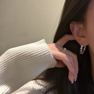 S925 sterling silver connected star hoop earrings worn by a model in warm light