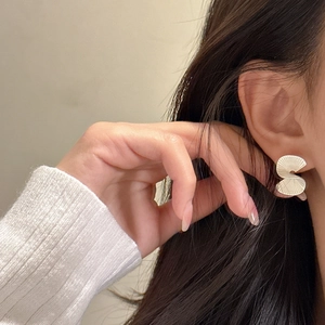 S925 sterling silver fan-shaped stud earrings with matte vintage metal texture on model