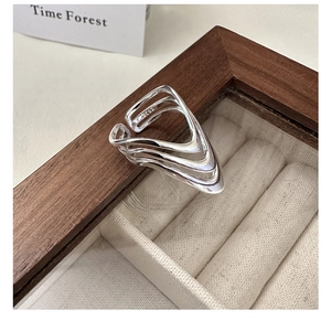 Close-up of S925 sterling silver multi-layer wavy ring with inner hallmark on wood tray