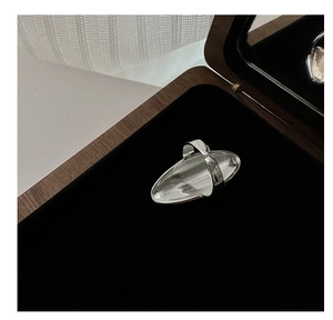 Detail of minimalist S925 sterling silver curved ring displayed in a luxury wooden box