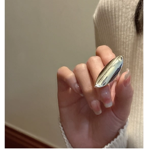 Close-up of a minimalist S925 sterling silver chunky oval statement ring worn by a model