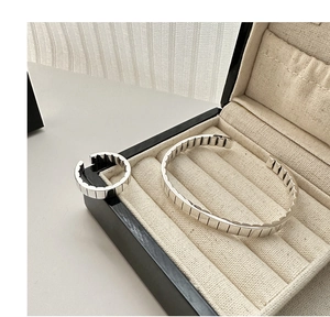 Close-up of S925 sterling silver gear textured open bracelet and ring set in jewelry box