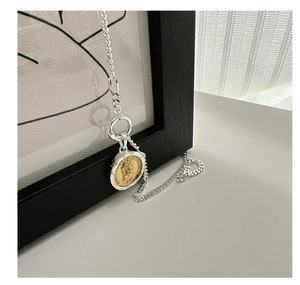 Detailed shot of retro silver necklace featuring a dual-tone Queen Elizabeth 1971 coin pendant