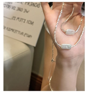 Detail of S925 silver irregular pearl necklace and bracelet set with square link chains