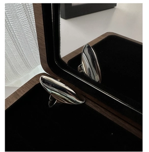 Macro view of polished S925 sterling silver curved ring in a luxury jewelry box