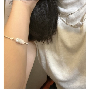 Detail view of silver S925 necklace and bracelet set with rectangular pearl elements