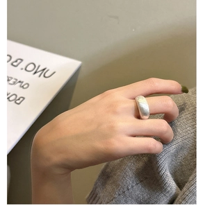 Macro detail of wide S925 sterling silver ring with textured brushed matte finish