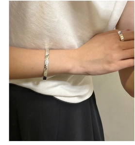 Close-up of S925 sterling silver gear bracelet and ring set on model's wrist