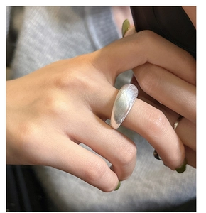 Close-up of minimalist S925 sterling silver wide ring with brushed matte finish on finger
