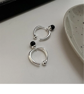Close-up of 925 sterling silver ring with black onyx bead in a minimalist French style