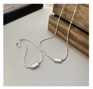 Macro detail of S925 sterling silver stamp on Baroque pearl necklace and bracelet