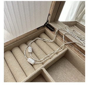 Macro shot of S925 silver irregular chain necklace with rectangular pearl accents