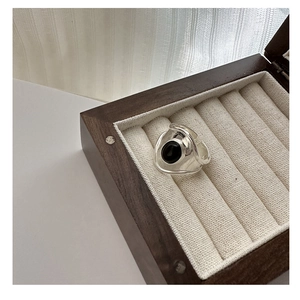 Detailed view of wide S925 sterling silver ring with oval black onyx and organic wavy band