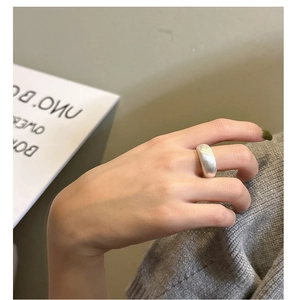 Detailed close-up of a wide brushed S925 sterling silver ring with a matte texture finish