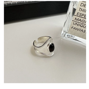 Close-up of S925 sterling silver ring featuring oval black onyx and S925 hallmark stamp
