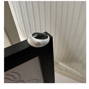 Detailed view of wide brushed S925 sterling silver ring with a minimalist matte finish texture