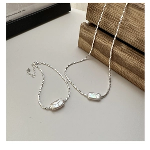 Detailed close-up of S925 sterling silver lobster clasp and square snake chain texture