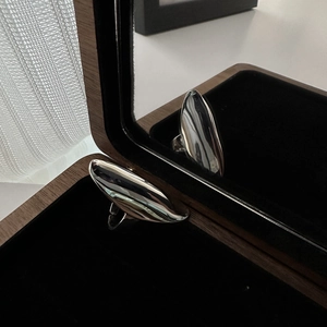 Polished S925 sterling silver curved oval ring displayed in a luxury wooden jewelry box