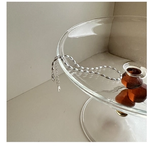 Detail of S925 sterling silver beaded bracelet with lobster clasp on a glass edge
