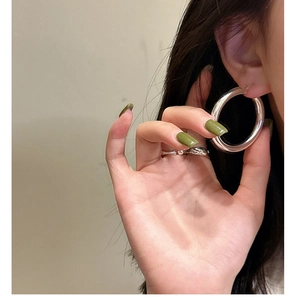 Close-up of a thick polished S925 sterling silver hoop earring worn on the earlobe