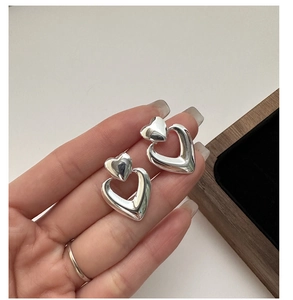 Detailed close-up of S925 sterling silver double heart earrings with polished finish