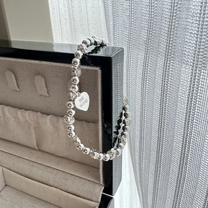 S925 sterling silver beaded bracelet featuring textured rhombic beads and Be Mine heart charm