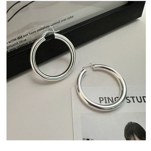 Close-up of S925 sterling silver hallmark on large minimalist polished hoop earrings