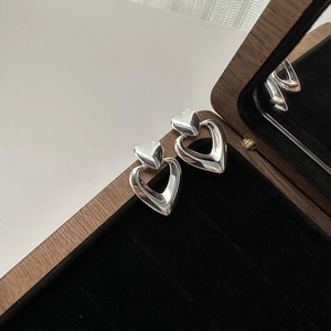 Minimalist S925 sterling silver double-layered heart stud earrings on a velvet display