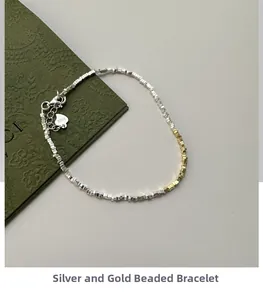 Detail of S925 sterling silver crushed nugget bracelet with gold beads and heart charm