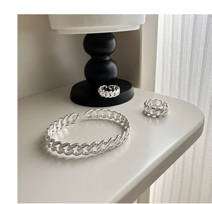 Close-up of S925 sterling silver woven twisted rings with detailed hallmark engraving