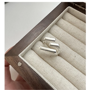 Detailed view of S925 sterling silver multilayer ring in a beige velvet jewelry box